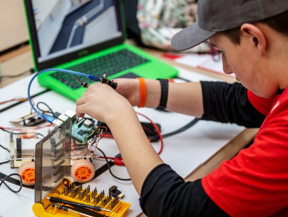 Young adult with a physical computing project.