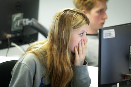 A girl in a university computing classroom.